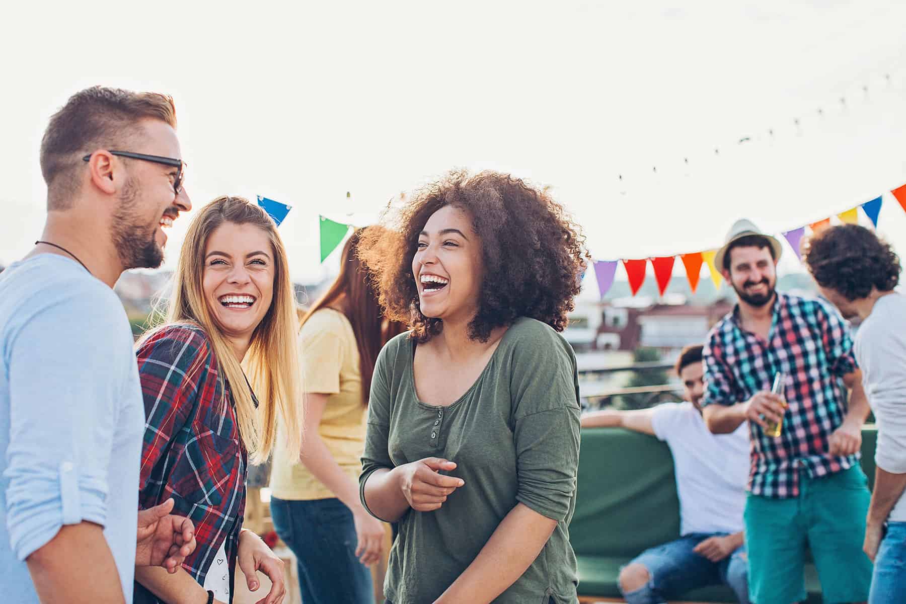 Friends at an outdoor party laughing