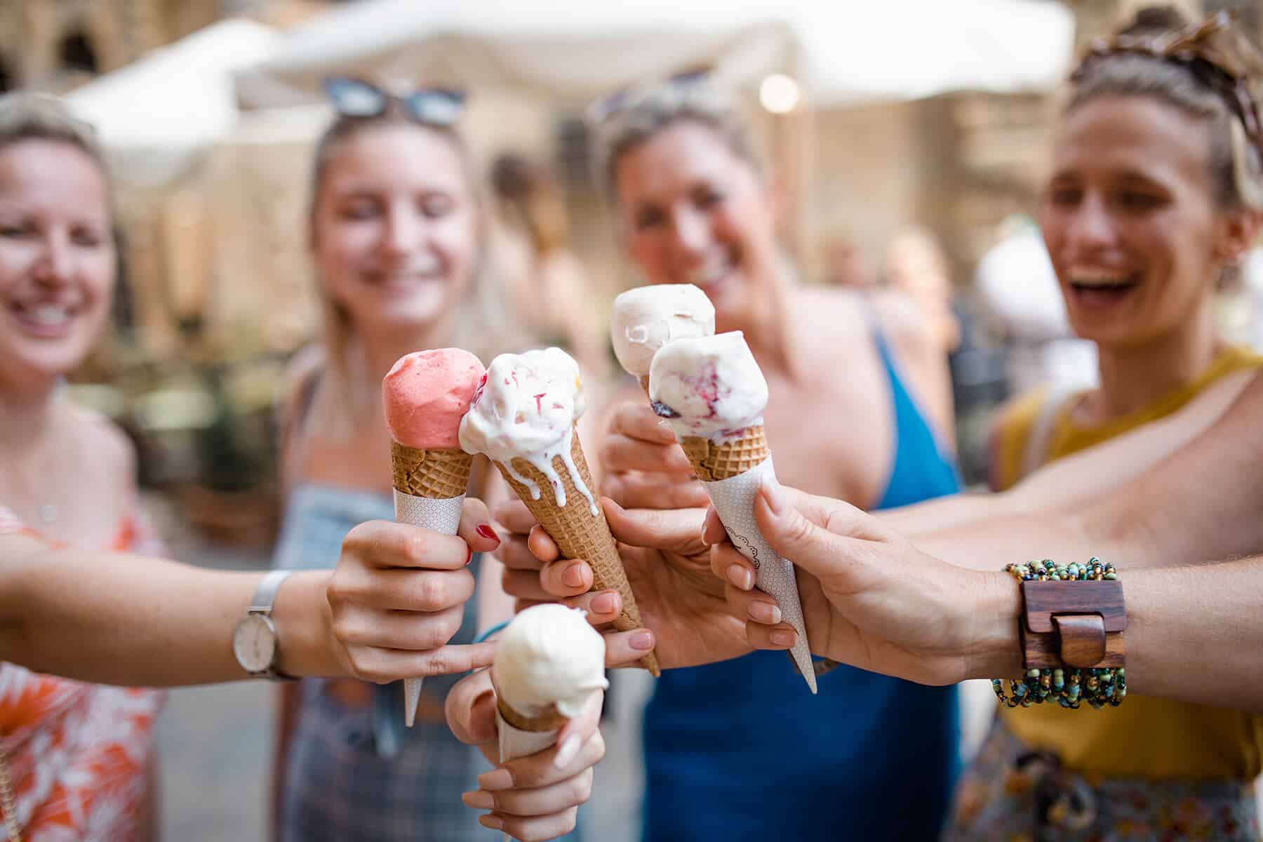 Group of women doing cheers with ice cream cones
